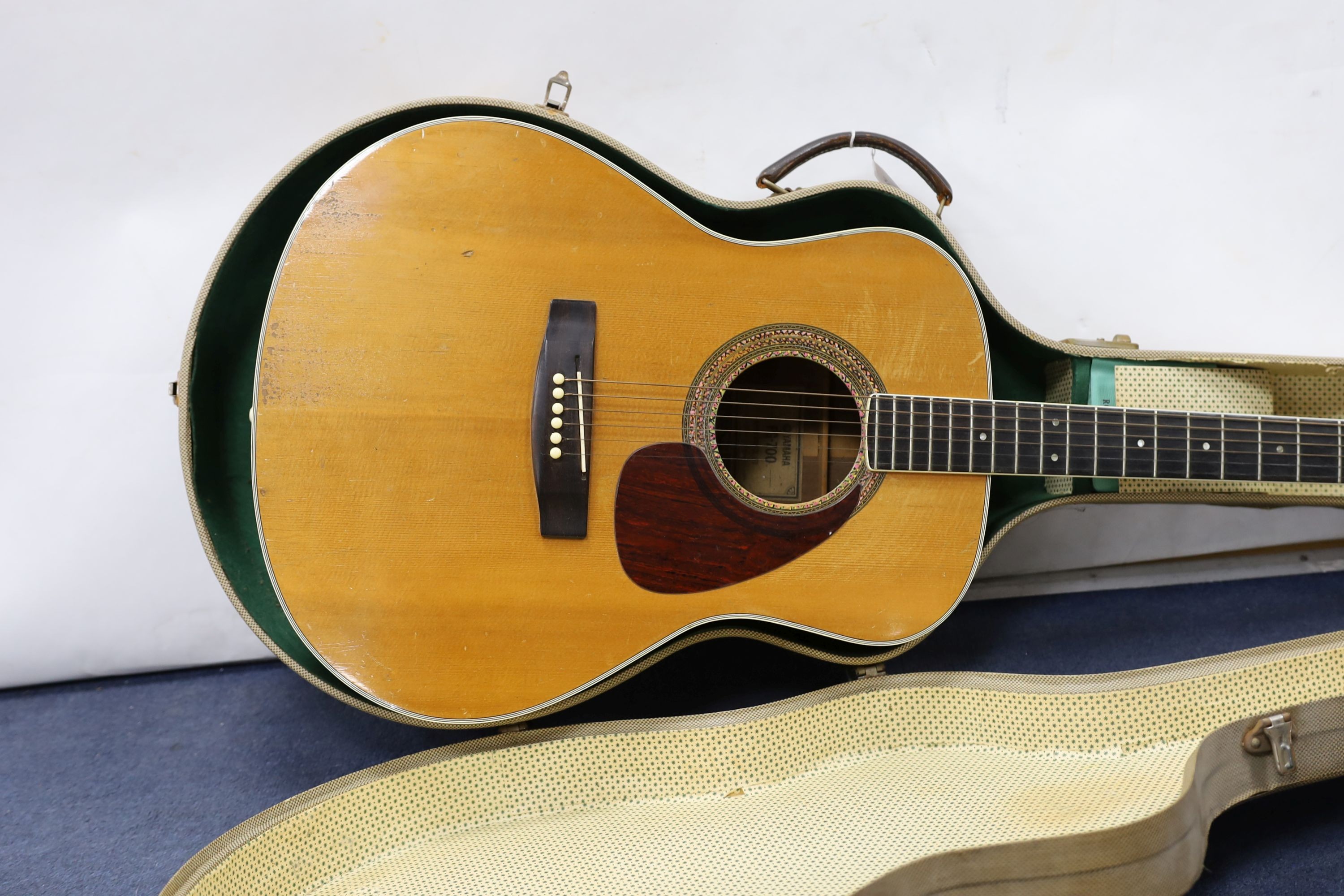 A Yamaha FG-700 acoustic guitar in hard case